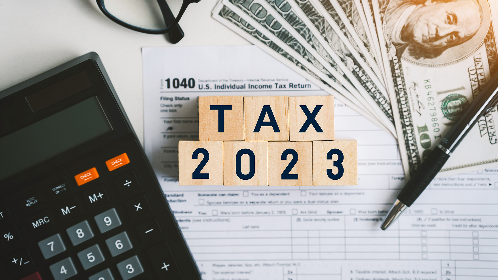 Tax text in wooden cubes and tax or vat form documents to complete Individual income tax return form for payment to Government